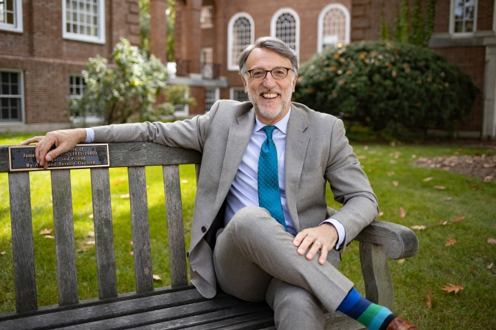 Dean of Admissions and Financial Aid Lee Coffin Sitting on a bench in fall