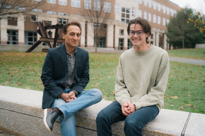 Alireza Soltani, associate professor of psychological and brain sciences, and Ethan Trepka '22 sit on a wall together