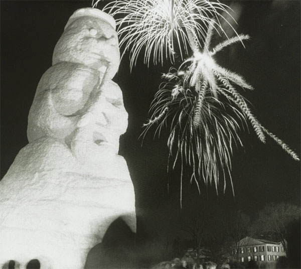 Large ice sculpture snowman with fireworks in the background