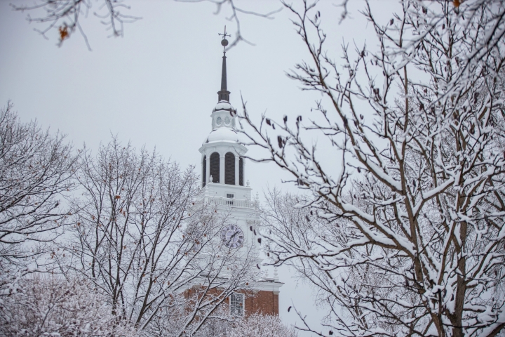 Snow covered trees in front of Baker Tower