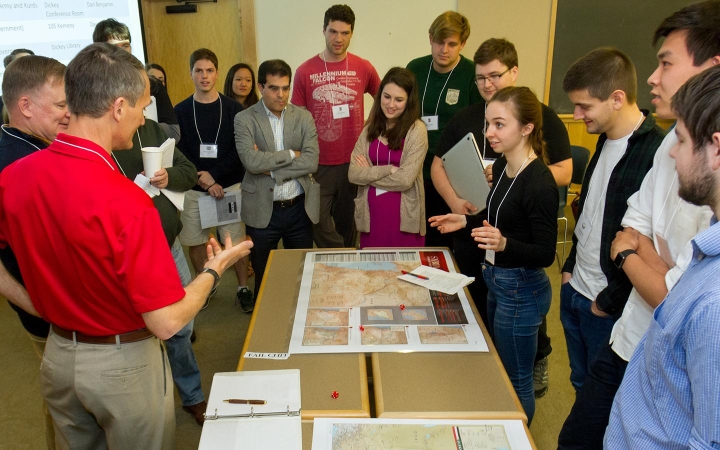 A group of people standing around a map