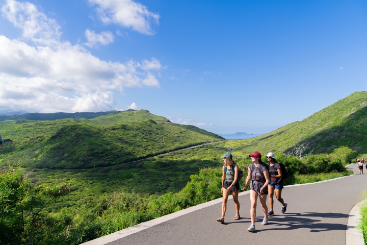 Students walk on a trail in Hawaii