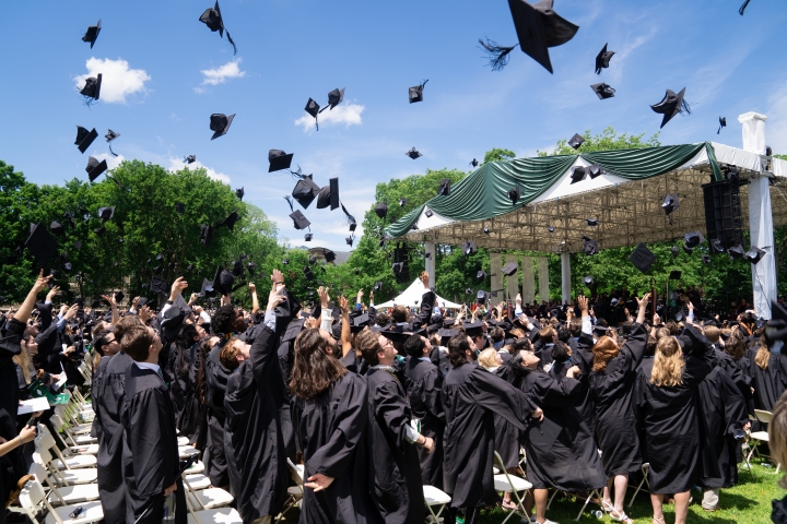Dartmouth graduates throwing their caps in the air