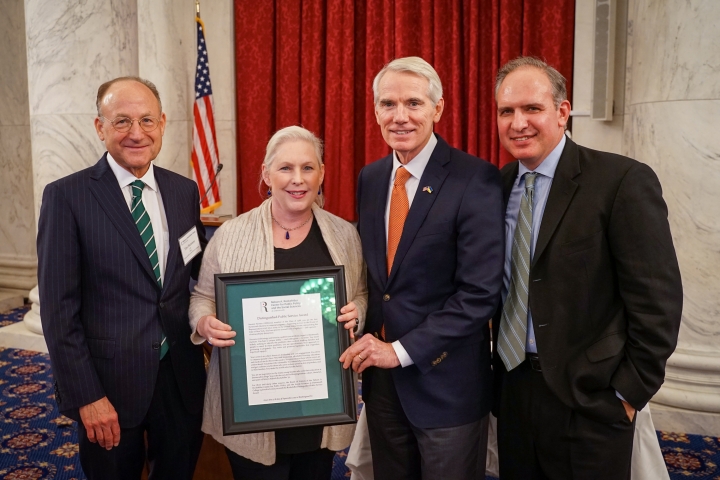 Timothy Harrison '78, chair of the Rockefeller Center Board of Visitors; Sen. Kirsten Gillibrand '88; Sen. Rob Portman '78, and Jason Barabas '83, center director.