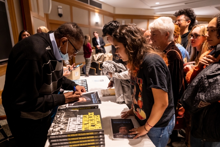 Bobby Seale signs books after his Dartmouth Political Union talk