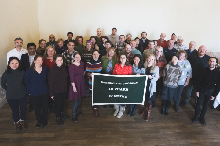 Group of people holding 10 years of service banner