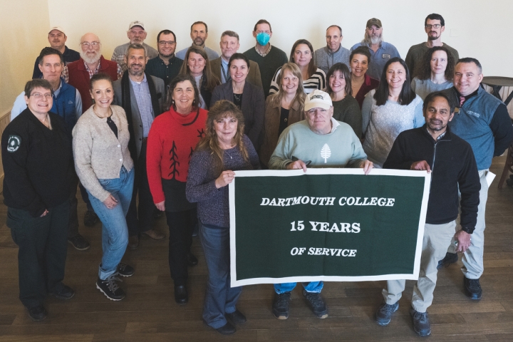Group of people holding 15 years of service banner