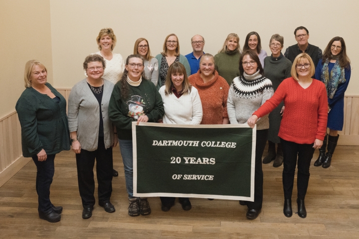 Group of people holding 20 years of service banner