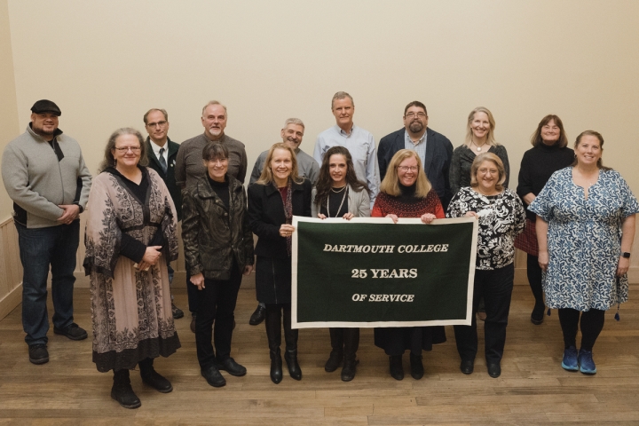 Group of people holding 25 years of service banner