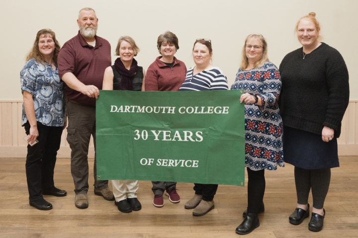 Group of people holding 30 years of service banner