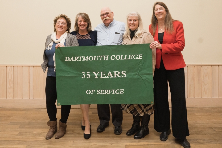 Group of people holding 35 years of service banner