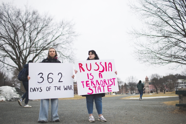Tonia Zakorchemna and Zhenia Dubrova hold signs in protest of Russia