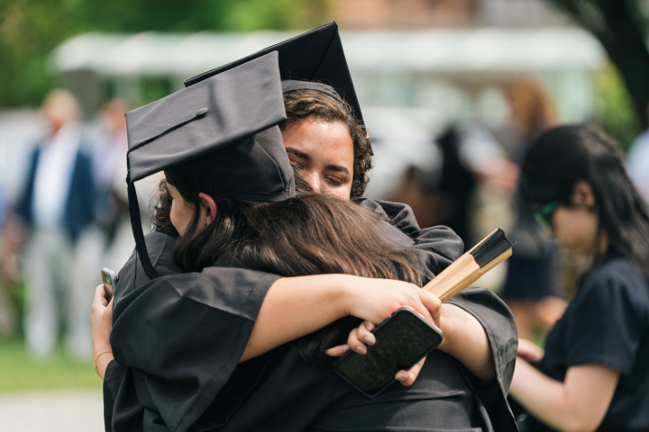 Graduates hug during Commencement at Dartmouth College