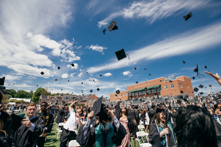 Commencement graduates throw their hats in the air at Dartmouth College