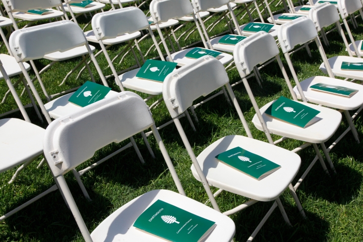 White chairs with the Commencement program on them from Dartmouth College