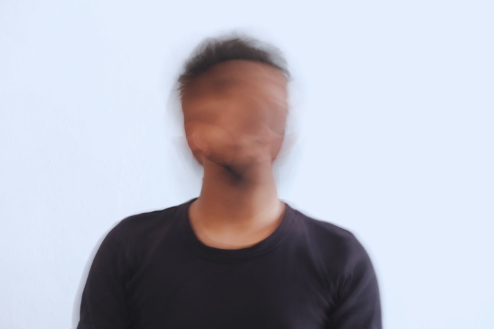 Blurred face of man wearing black shirt