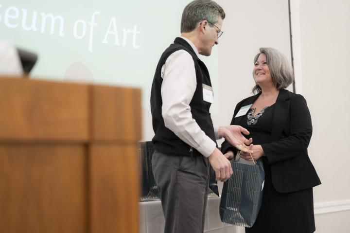 Sharon Reed accepting a gift from David Kotz