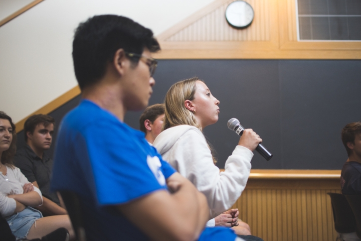 Student with microphone asks a question
