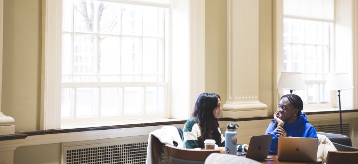 Two students chat in Reiss Hall