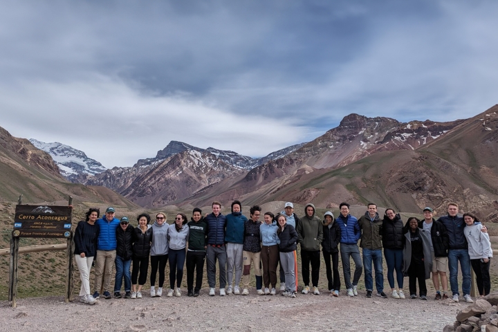 Students pose in front of mountains