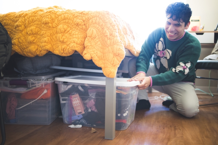 Jaime Aranzabal '24 pulls out a bin full of wardrobe accessories