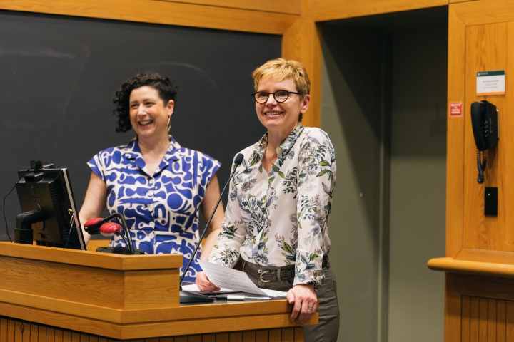 Dialogue Project co-directors standing at a podium