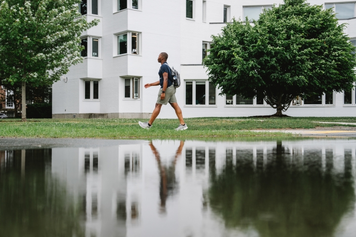 Student walks by large puddle