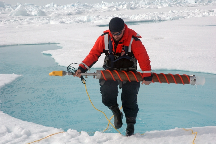 Christopher Polashenski carrying an ice core