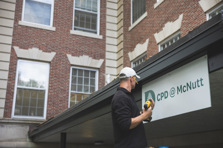 Mike Sauer hanging a sign