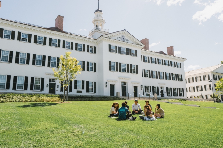 Dartmouth Hall with students sitting on the lawn