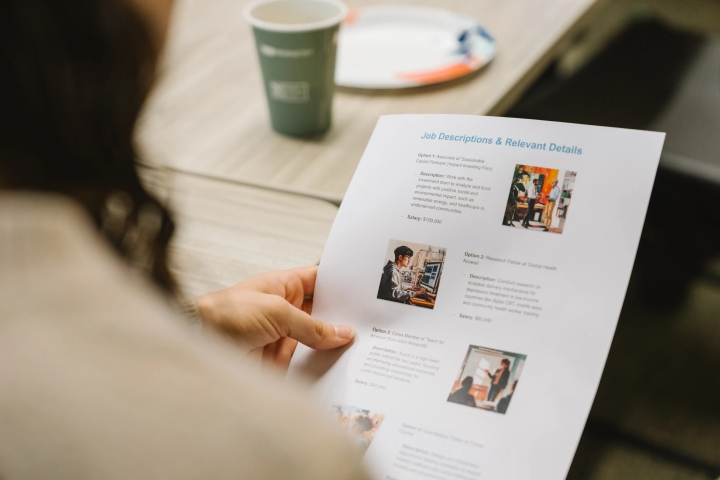 Person reading a paper handout