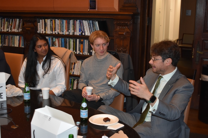 Francina Kolluri and Nicholas Booth talking with Aaron Klein