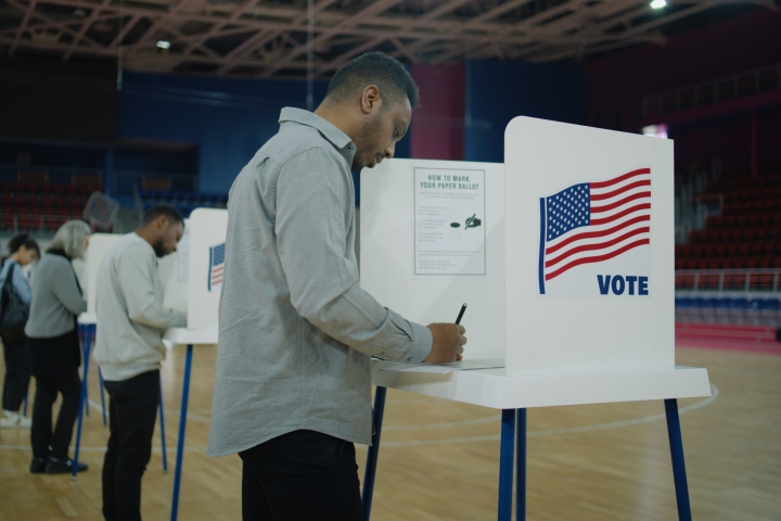 Man voting at voting booth