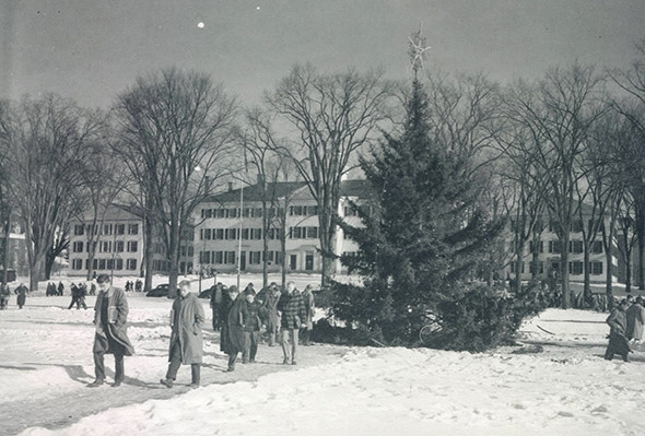 Students walk by the 1940 Christmas tree on the Green