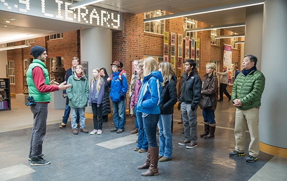 Reed Wommack ’14 leads an admissions tour group through Baker-Berry Library