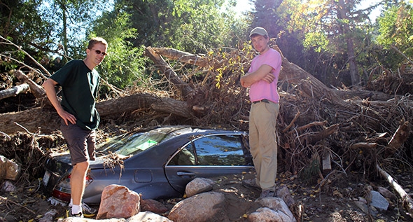 Professor Carl Renshaw, left, and graduate student Jimmy Voorhis survey the damage in the wake of flooding in Boulder, Colo.