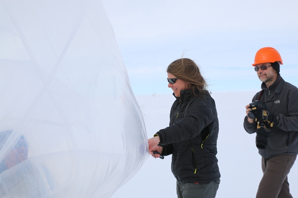 Associate Professor of Physics and Astronomy Robyn Millan and colleague Dave Milling from the University of Alberta deflate a balloon that had a hole in it