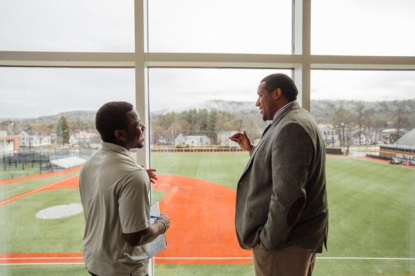 Donald Brooks, right, and student-athlete Matthew Shearin ’19 hold a conversation with a view of Memorial Field.