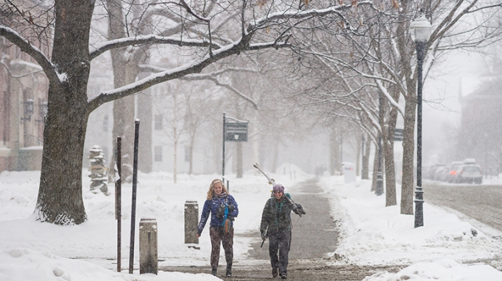 two students walking together in the snow