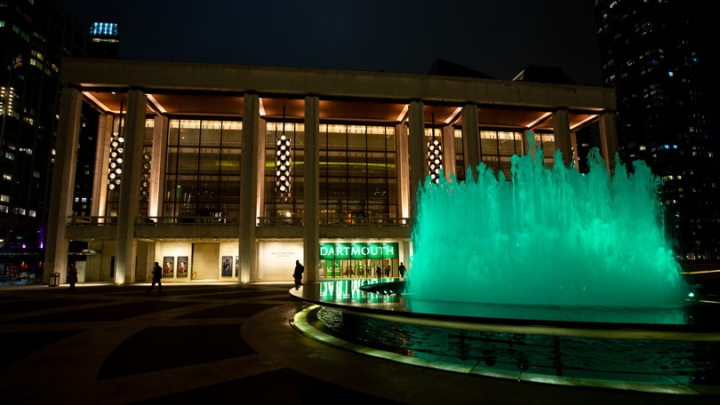 A fountain is lit green
