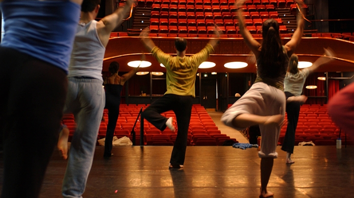 students rehearsing a dance number on stage