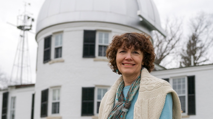 Mary Hudson standing in front of the observatory building