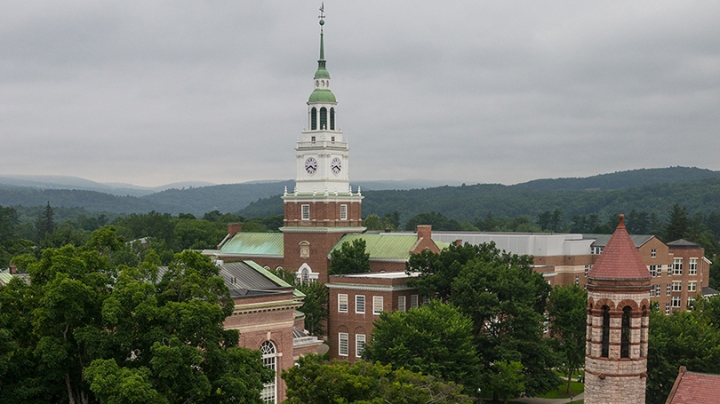 Baker Tower with clouds and mountains behind it.