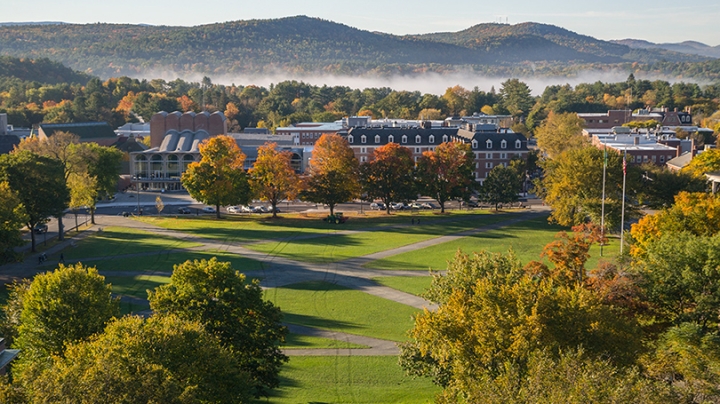 An image from Baker Tower overlooking the Green on an autumn day as fog rises in the mountains behind town.