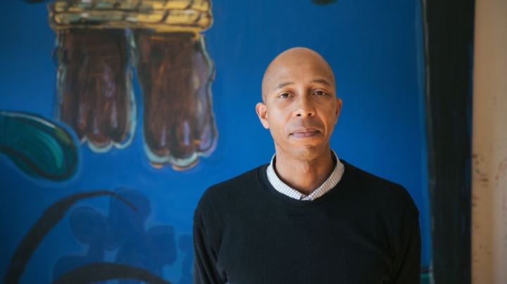 Enrico Riley in front of one of his paintings