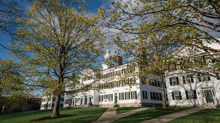 the outside of Dartmouth Hall with green leaves on the trees