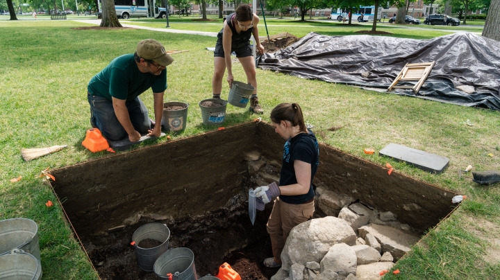 Professor Jesse Casana and students excavate an old privy.