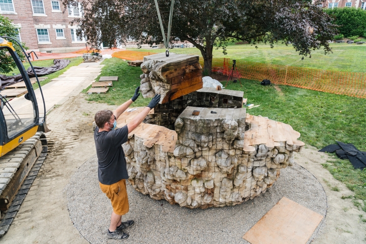 The sculpture being installed in its permanent place on campus.