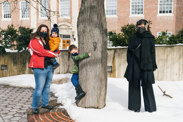  Assistant professors of geography Abigail Neely, left, and Patricia Lopez, right, meet up for a socially distanced discussion of their research on campus, joined by Neely's sons, Theodore, 18 months, and Liam, 8, (hugging the tree).