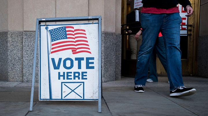 a Vote Here sign outside of a polling place